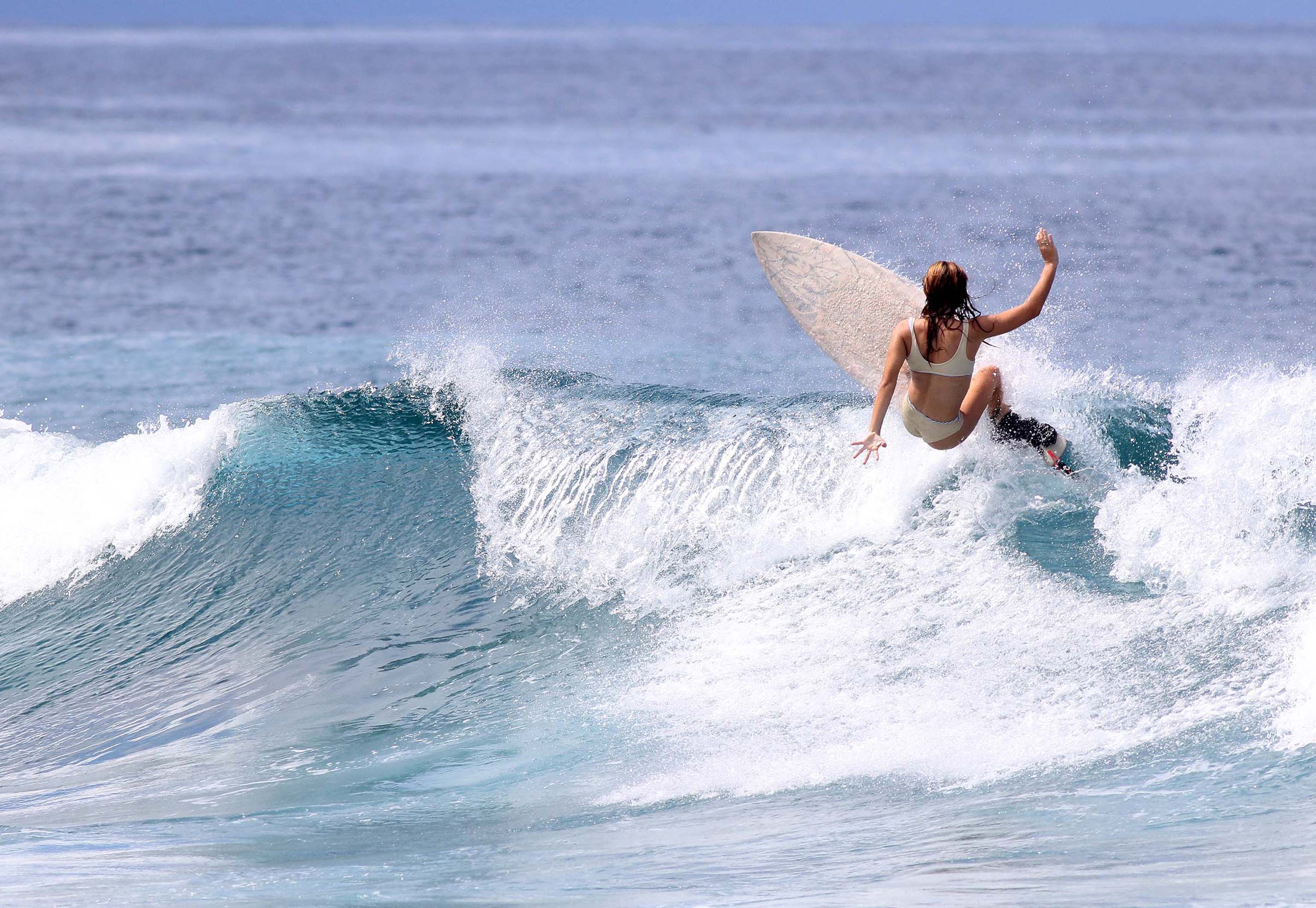 Surfer carving a turn on a clean wave